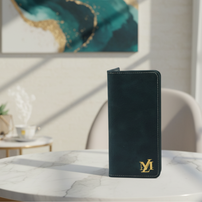 Black leather wallet with gold logo on a marble table, abstract painting in the background
