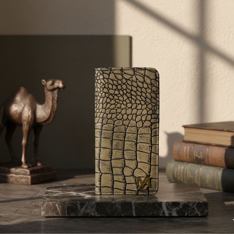 Leather wallet with crocodile pattern on a marble surface with books and a camel statue in the background
